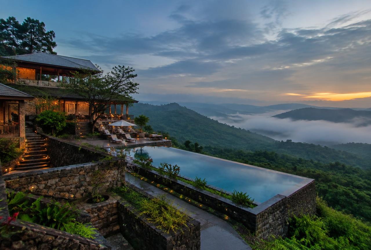 Hillside resort with infinity pool overlooking a Sahyadri valley