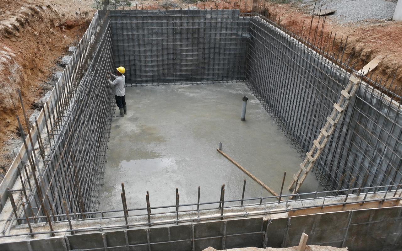 Underground RCC water tank under construction with rebar walls